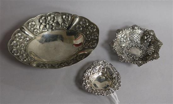 Two pierced silver bonbon dishes and a larger silver dish.